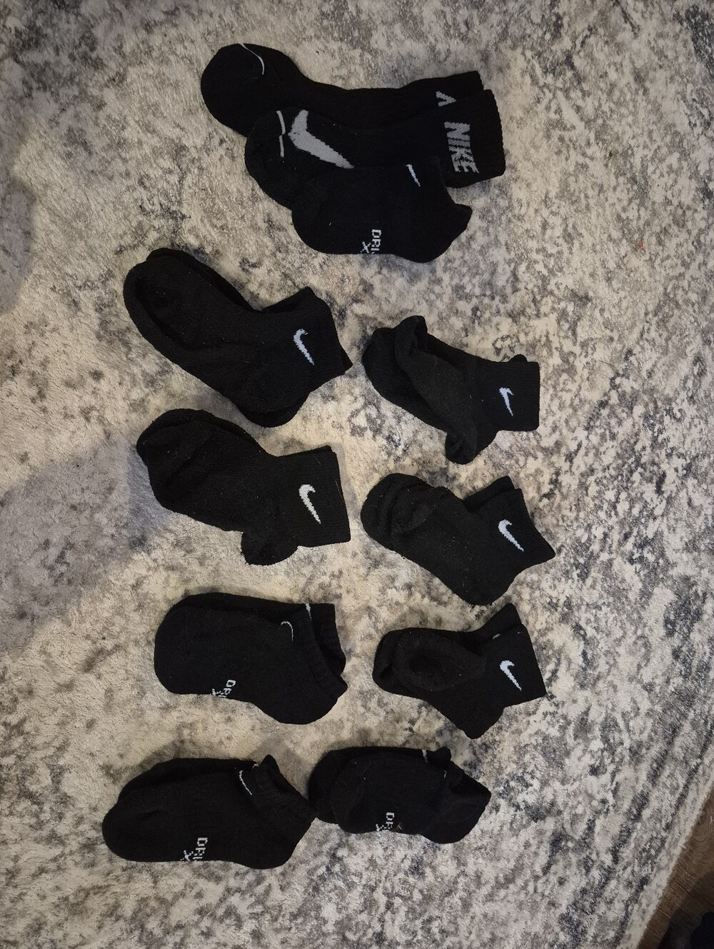 8 pairs of Nike black xs socks and 3 extra no matches socks